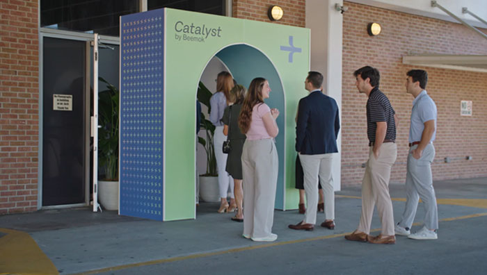 People lined up outside a “Catalyst by Beemok” event entrance.